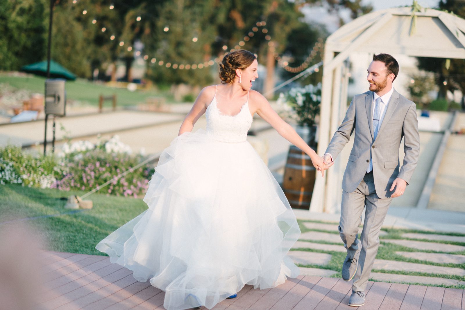 Bride and groom running at Limoneira Ranch Wedding by San Luis Obispo Wedding Photographer Yvonne Goll Photography