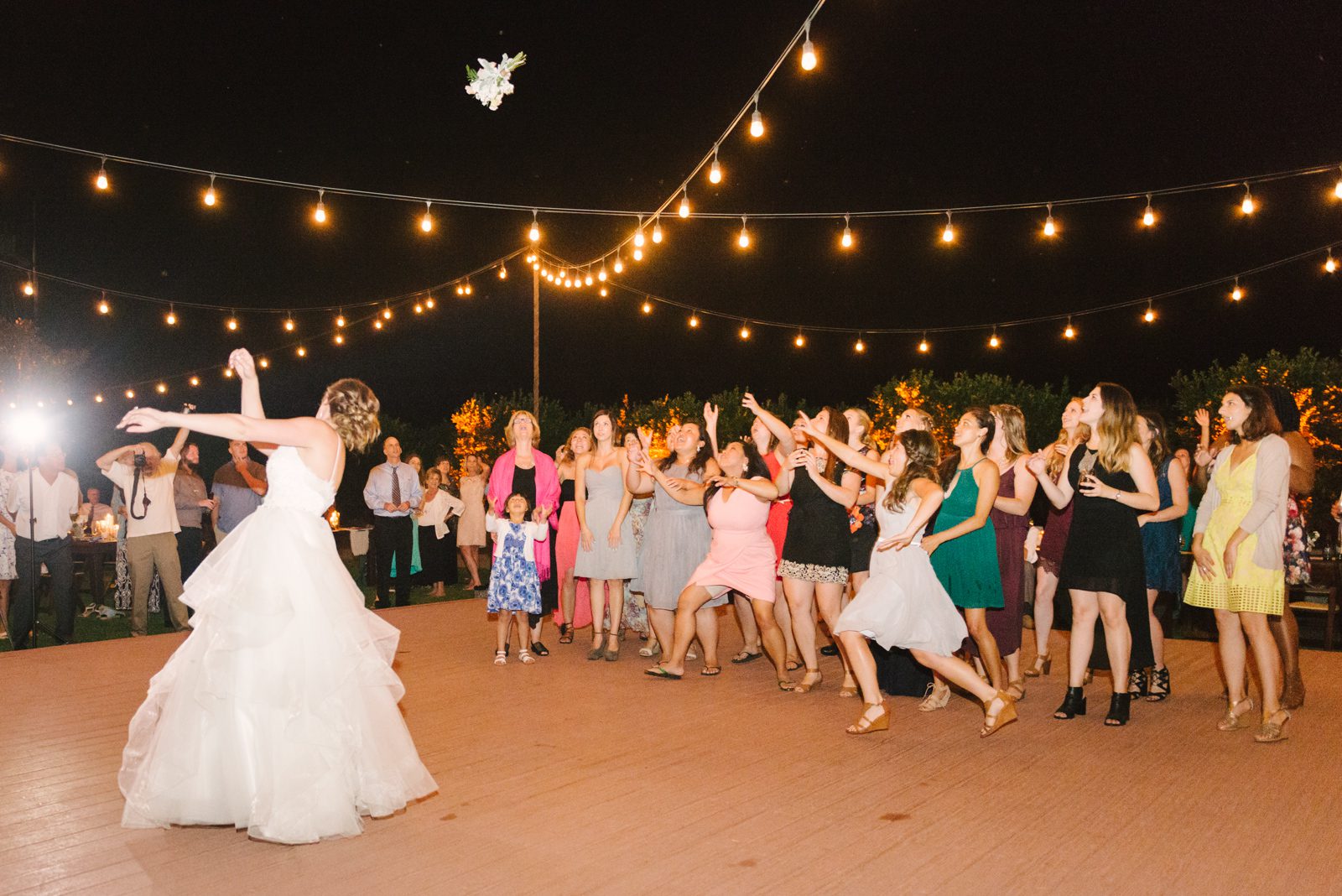 Bride throwing bouquet at Limoneira Ranch Wedding by San Luis Obispo Wedding Photographer Yvonne Goll Photography