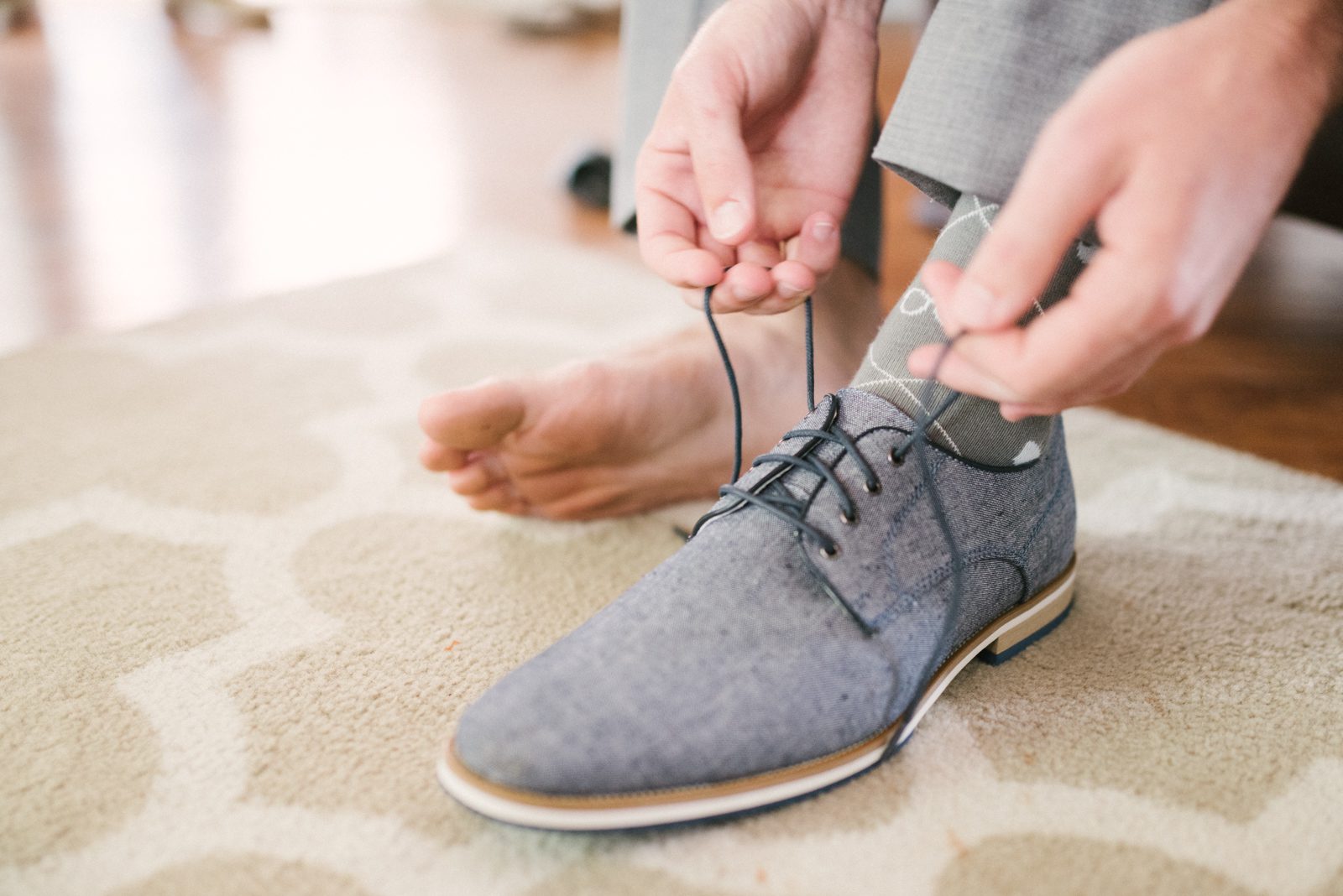 Groom tying shoes at Limoneira Ranch Wedding by San Luis Obispo Wedding Photographer Yvonne Goll Photography