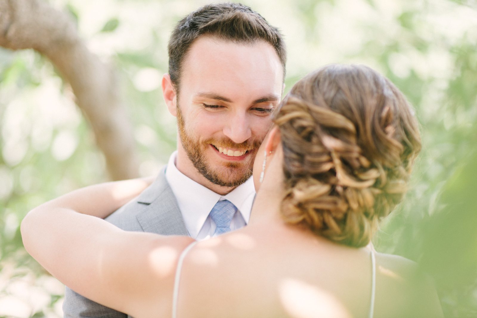 Groom laughing at Limoneira Ranch Wedding by SLO Wedding Photographer Yvonne Goll Photography