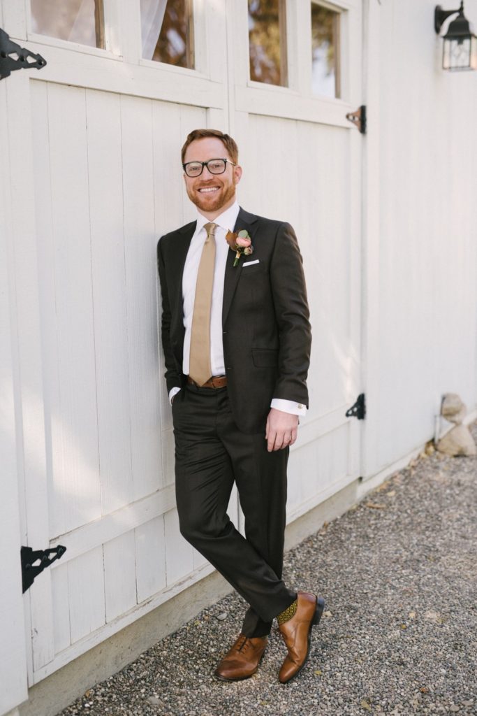 Groom in dark suit with gold tie