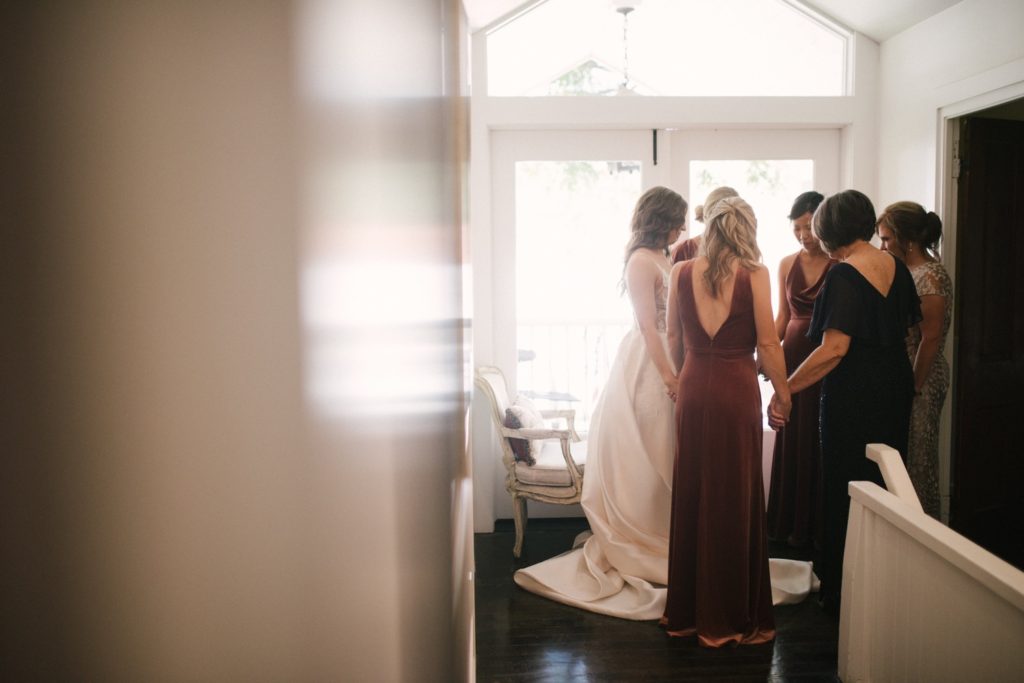 Bridesmaids pray together before the wedding