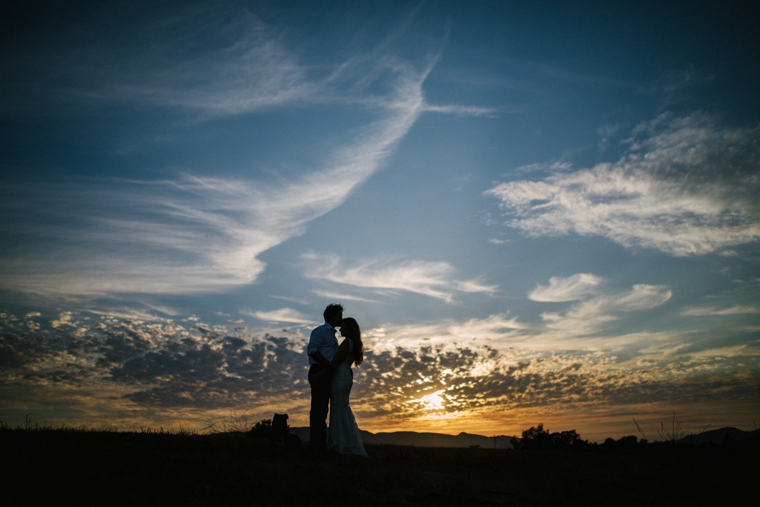 bride and groom kiss at sunset at flying caballos ranch. san luis obispo wedding photographer