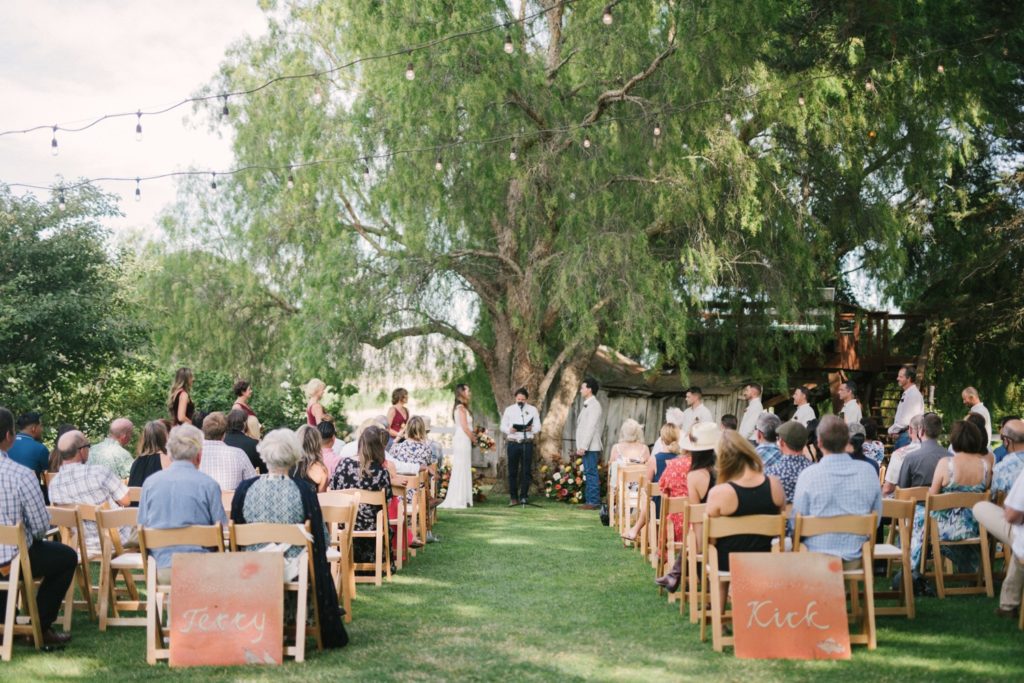 wedding ceremony held under the trees at flying caballos ranch. yvonne goll photography