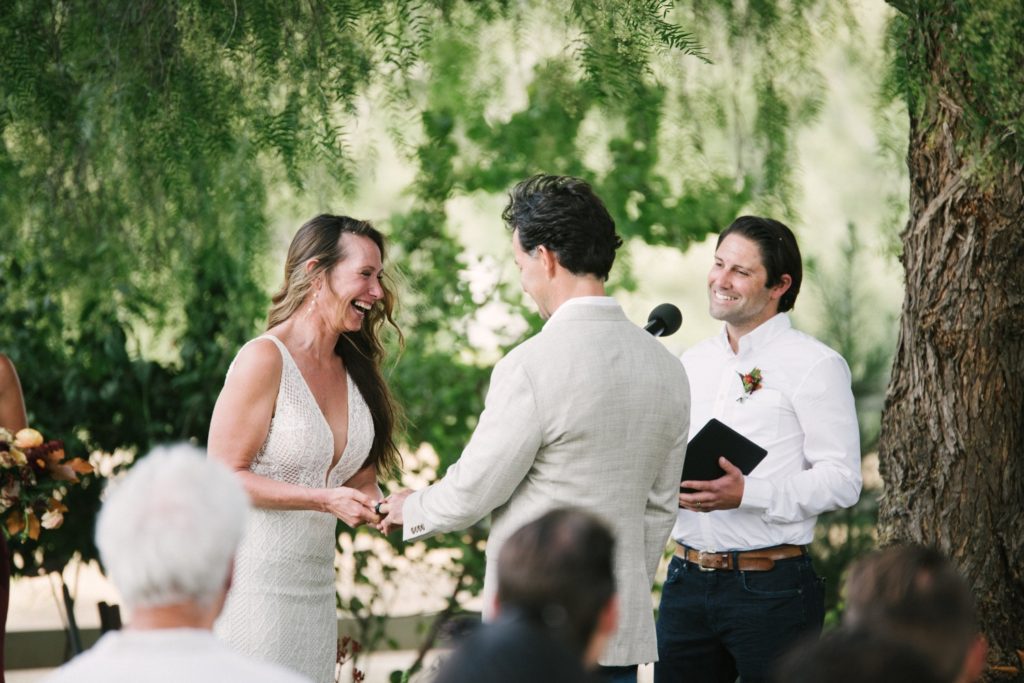 bride and groom get married in the yard at the farmhouse at flying caballos ranch. san luis obispo wedding photographer