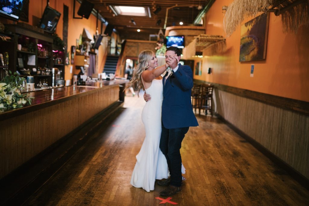 bride and groom share an intimate first dance at creeky tiki, where they met. slo wedding photographer