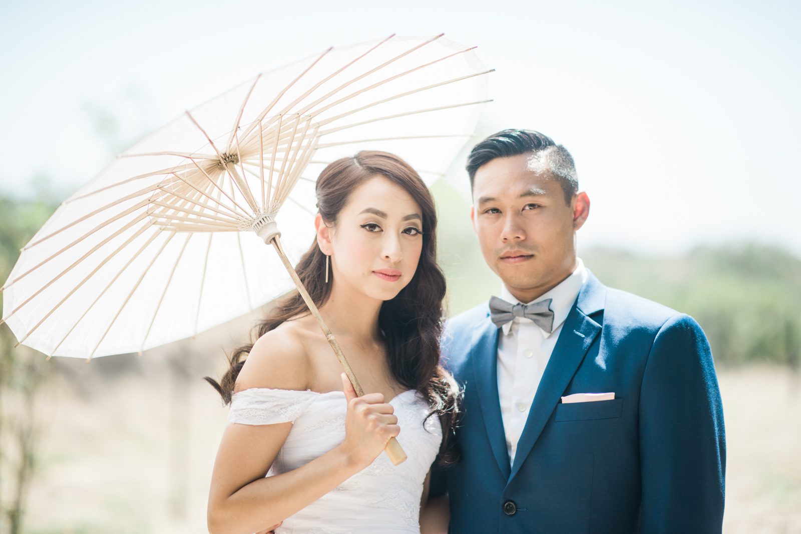 Bride and groom with white parasol at Hartley Farm Wedding by Paso Robles Wedding photographer Yvonne Goll Photography