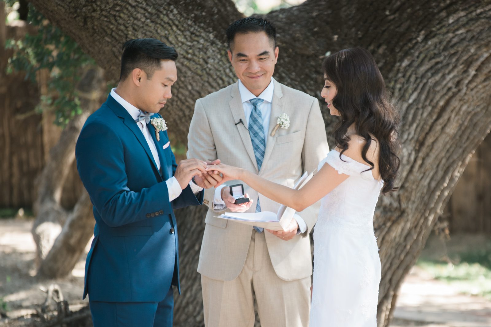 Groom placing ring on bride's finger at Hartley Farm Wedding by San Luis Obispo Wedding photographer Yvonne Goll Photography