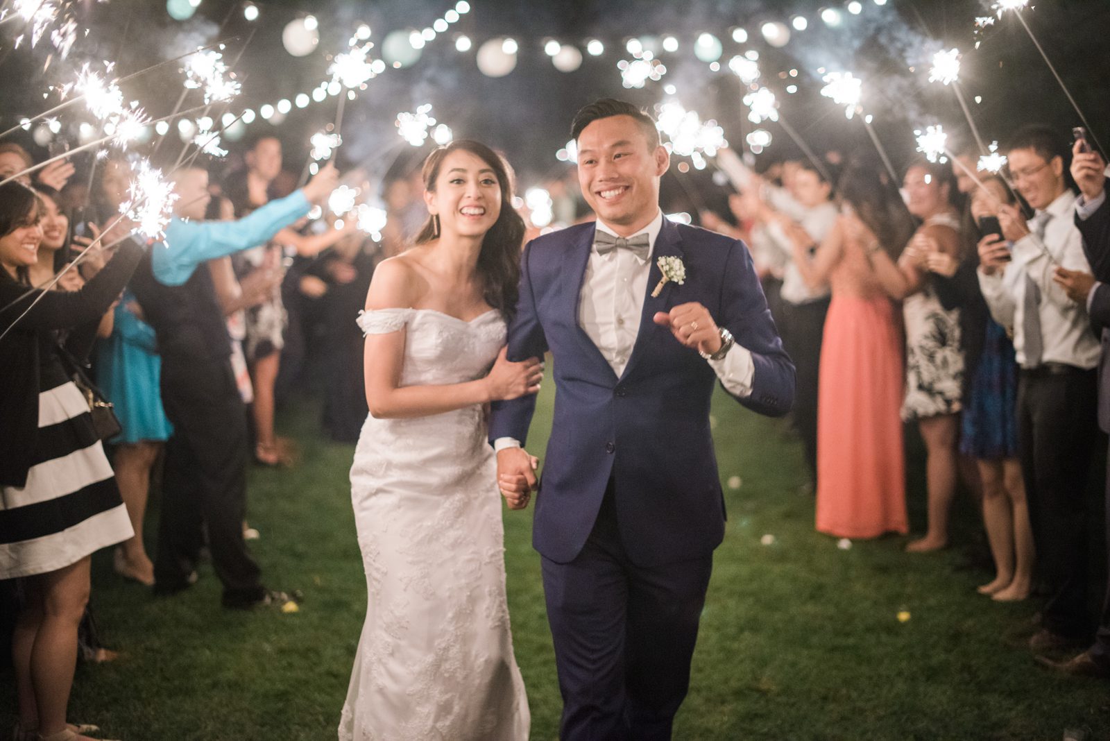 Bride and groom running through sparklers at Hartley Farm Wedding by San Luis Obispo Wedding photographer Yvonne Goll Photography