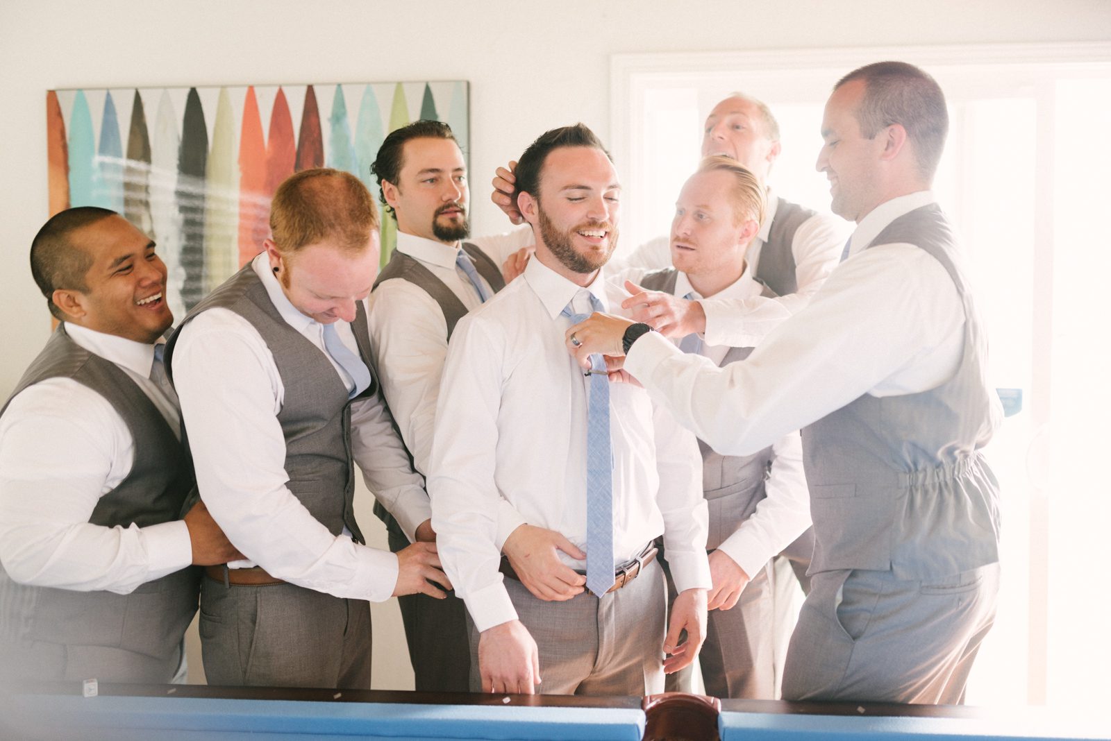 Groomsmen helping groom at Limoneira Ranch Wedding by SLO Wedding Photographer Yvonne Goll Photography