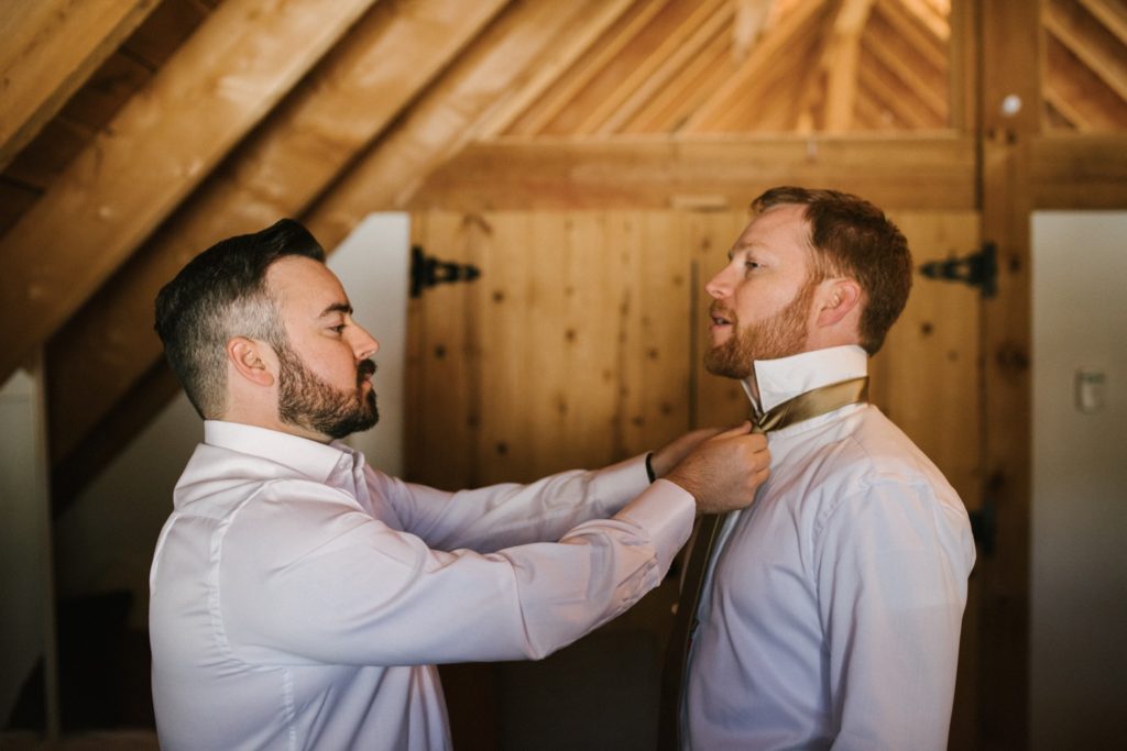 Best man helps the groom get ready for his wedding