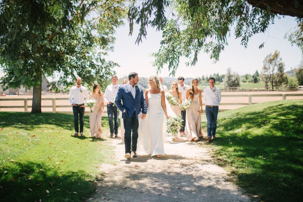 bride and groom walk with their wedding party at marfarm. wedding photographer san luis obispo